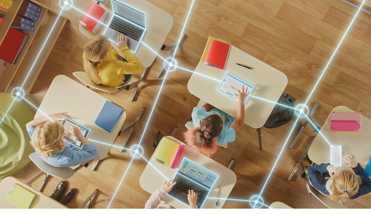 Connected classroom of students using laptops and tablets